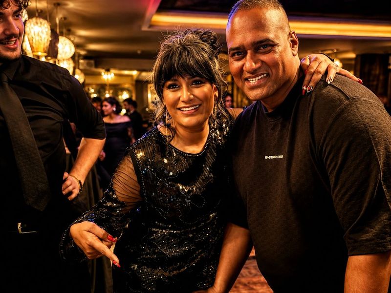 Two smiling guests in evening wear at a fun casino party