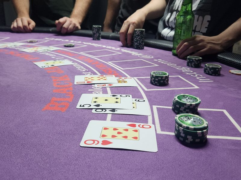 Close-up of playing cards and chip stacks on a blackjack table