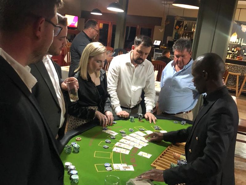Croupier dealing blackjack to guests at a corporate fun casino function